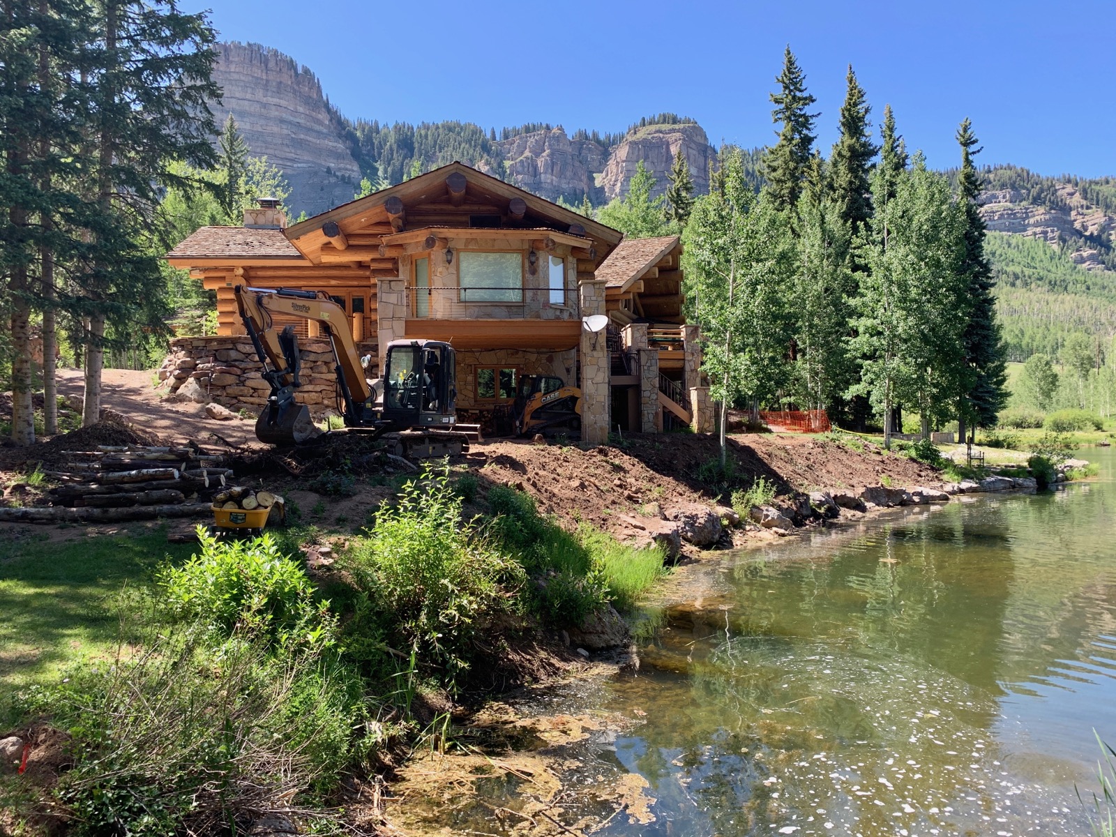 Excavation Services around the lake and rock retaining wall.